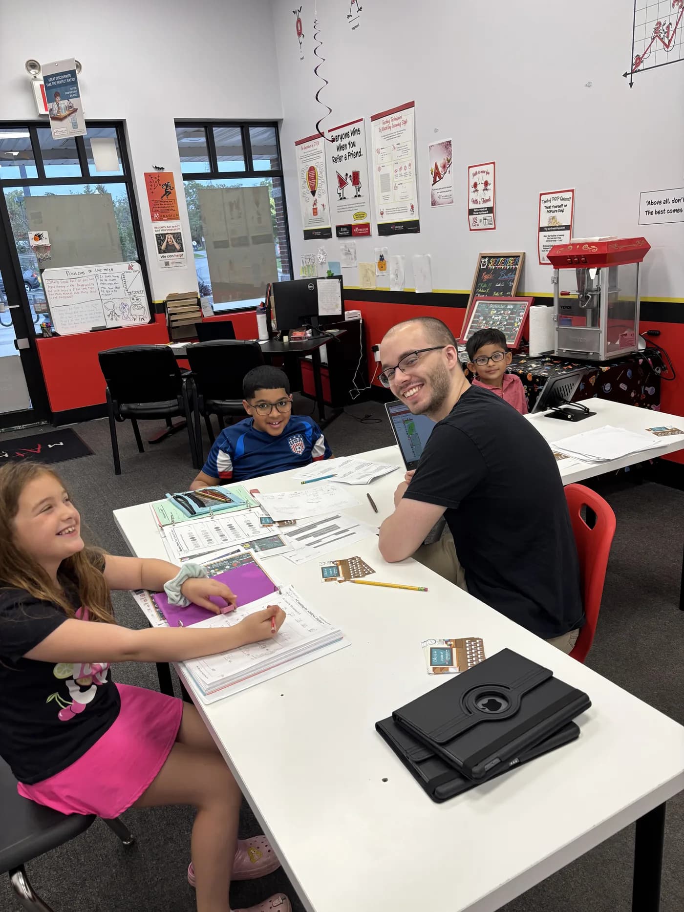 Mathnasium instructor helping students learn together