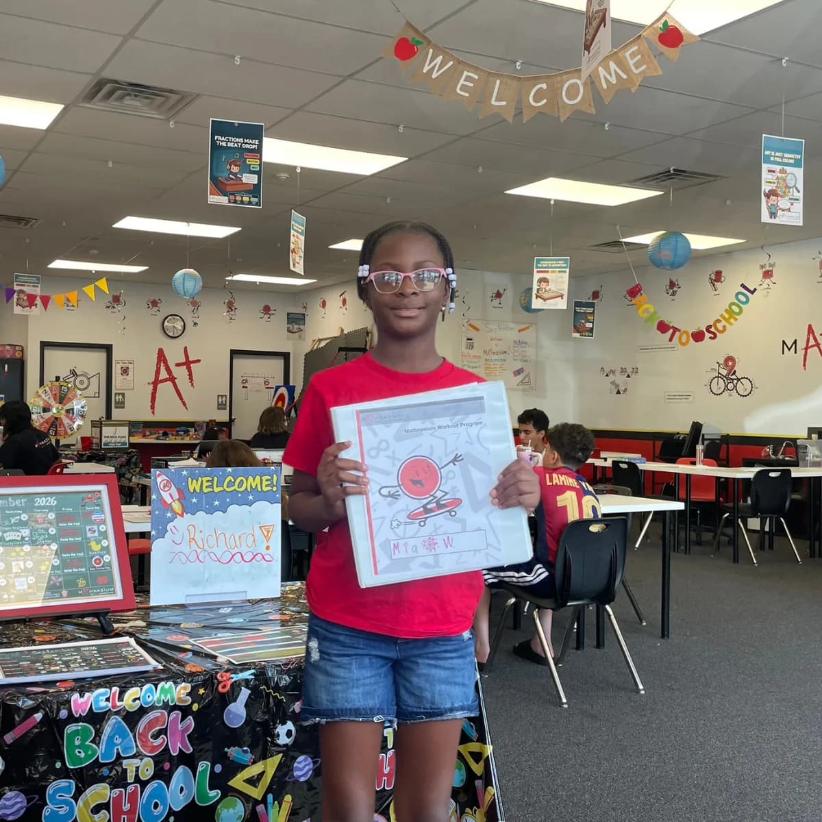 A student holding a Mathnasium folder inside the Westmere center