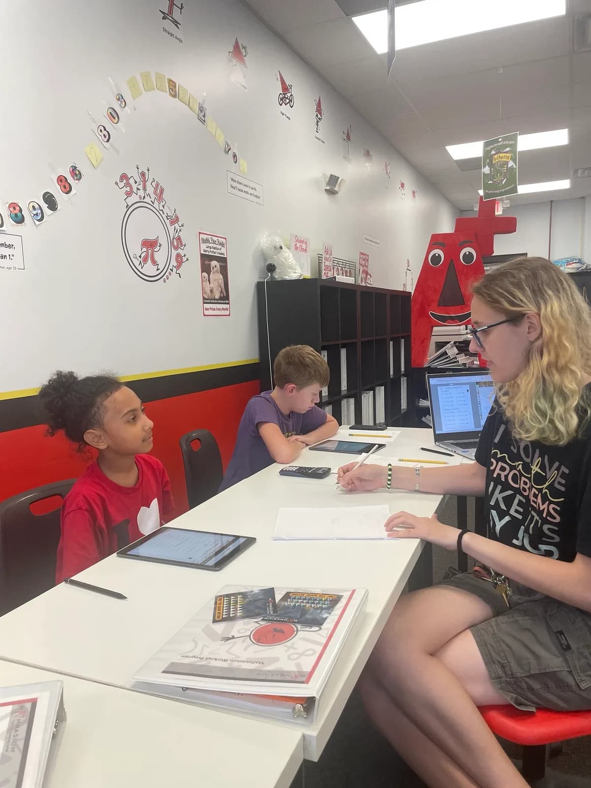 Students and an instructor reviewing math work at Mathnasium of Westmere