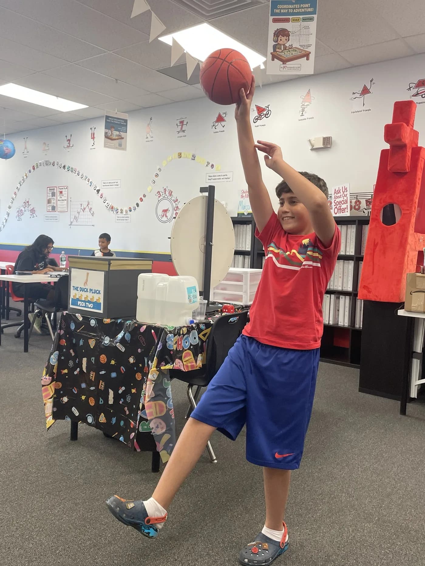 A student holding a basketball at Mathnasium of Westmere